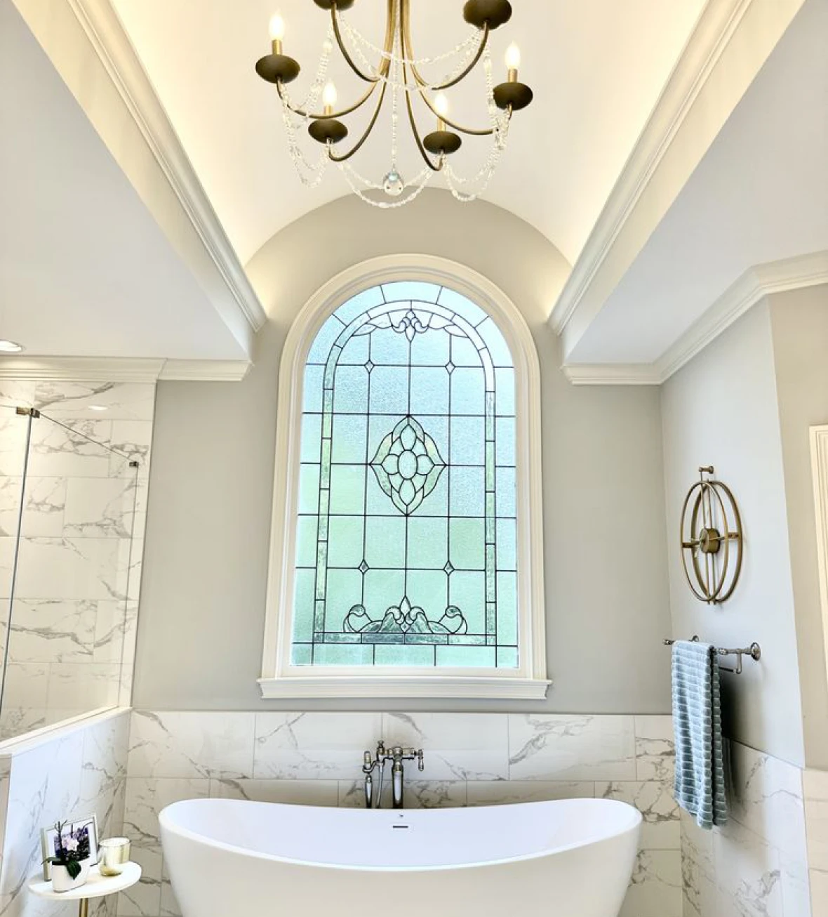 Luxurious white bathtub under arched window